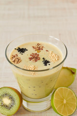 Homemade smoothie made from apple, kiwi and lime with raw seeds