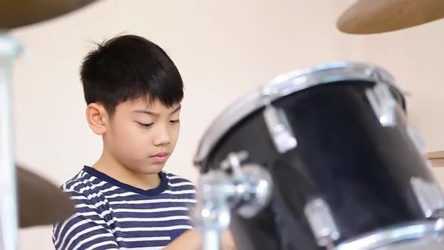 Closeup of asian child drummer practicing for a performance