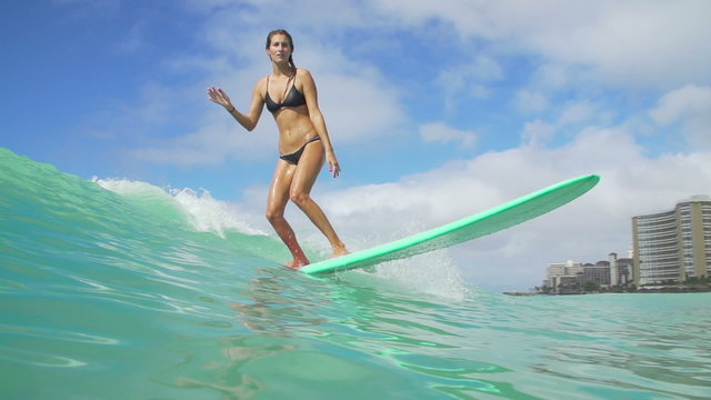 Slow Motion Surfer Girl Riding Wave On Sunny Summer Day