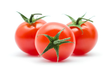 tomatoes with green leaves isolated on white background