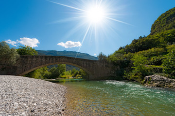 Roman Bridge and Sarca River - Italy / Ancient roman bridge over the Sarca river in the Sarca...