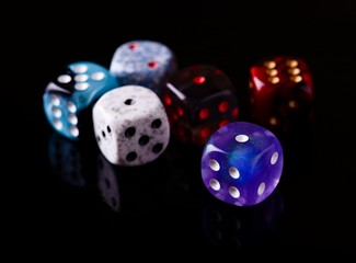 Six color dices on black board
