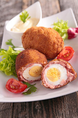 fried egg with sausage and breaded