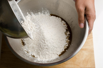 Pouring flour in the bowl for bakery cooking