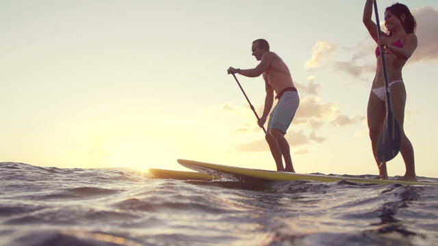 Slow Motion Silhouette Happy Couple Stand Up Paddling Boarding In Ocean 