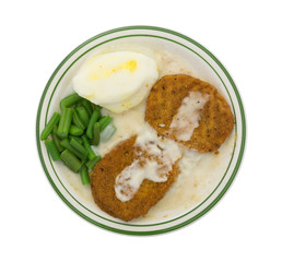 Fried chicken patties TV dinner on plate top view
