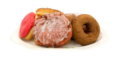 Several donuts and fritter on an old platter