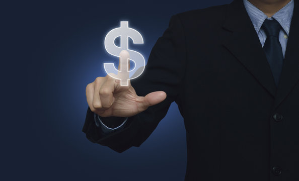 Businessman hand pushing dollar currency icon over blue backgrou