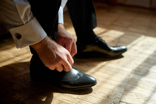 Business Man Tying Shoe Laces On The Floor