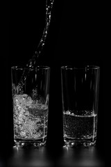 at two glass clean water is poured