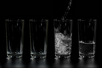 at four glass clean water is poured