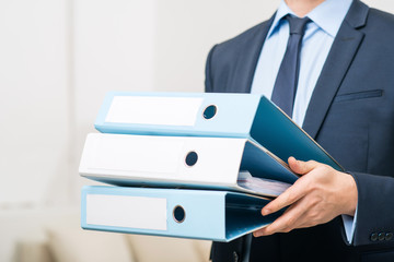 Professional office worker holding folders 