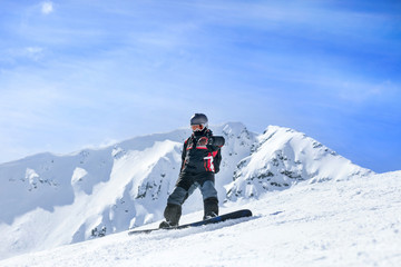 Fototapeta na wymiar snowboarder in action at the mountains