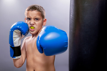 angry young child with boxing gloves