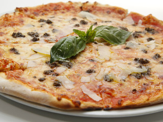 Delicious fresh pizza with meat, parmesan and basil on white background
