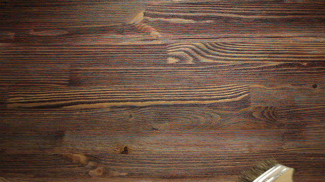 Wood painting with a brush with the brown color