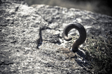 Rusted hook in a stone - Toned image with copy space