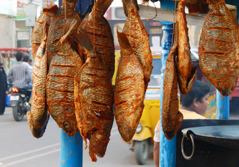 Indian street vendor sell fish fry food on a busy road in Hyderabad,India