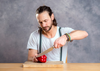 young bearded man with cooking pot