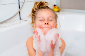 funny girl with foam bathtub in the bathtub