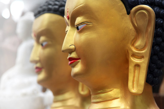 Close up shot of golden Buddha statues