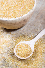 Brown sugar cane on the wooden background.