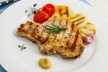 Grilled pork chop with mustard, onion