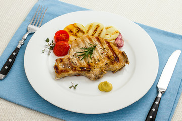 Juicy grilled pork chop, onion rings