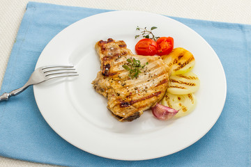 Juicy grilled pork chop with onion