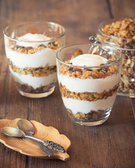 Healthy Breakfast - yogurt with homemade granola on the bright wooden board