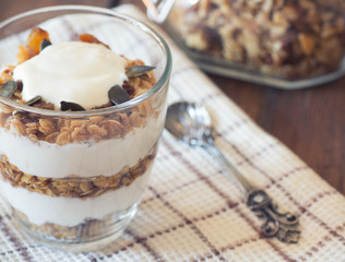 Healthy Breakfast - yogurt with homemade granola on the bright wooden board