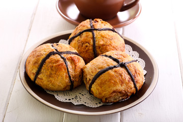 Chocolate hot cross buns on plate