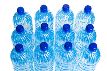 Closeup on rows of refreshing natural mineral water in plastic bottle in white background