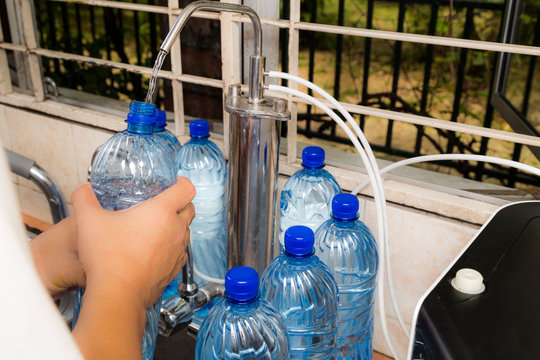 Person recycle empty plastic bottle from filtered tap water deemed as unhealthy practice