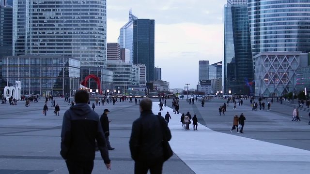 People walk in a modern district of Paris