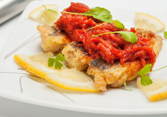 Pieces of fried fish with vegetable marinade.
