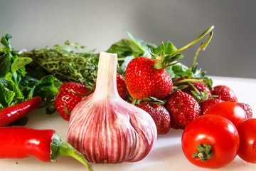 Fresh vegetables and fruits are on the table.
