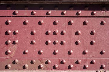 rivets in a red steel plate
