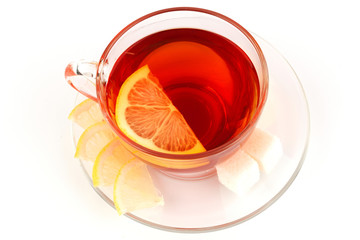 Glass cup of tea with pieces of white sugar
