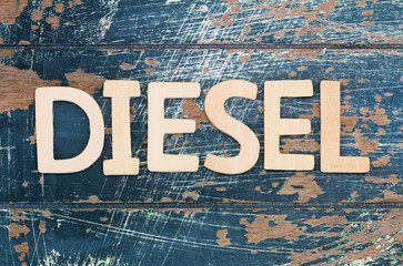 Word diesel written with wooden letters on rustic surface
