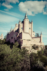 Fototapeta na wymiar Segovia, Spain. The famous Alcazar of Segovia, rising out on a r