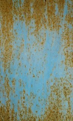 Blue background.Paint on rusty metal surface