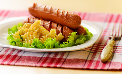 Fried sausage with pasta.