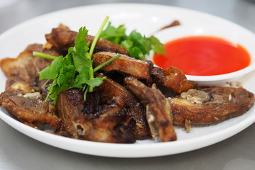 Deep fried sliced duck with chili sauce on white plate asian style