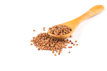 Uncooked buckwheat on wooden spoon