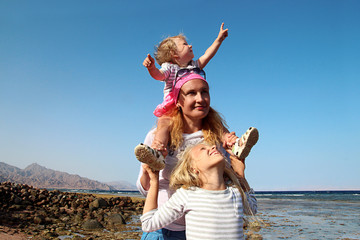 Mother with two daughters on beach