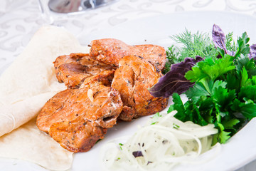 Grilled pork on white plate