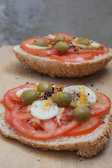 Healthy sandwich made with soy rolls with tomato, onions, green olives and spices.
