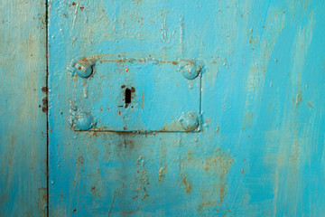 keyhole on metal doors painted in blue