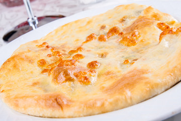 Khachapuri with meat on white plate